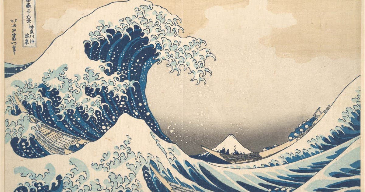 Hokusai's Great Wave rises above boats with Mount Fuji in the distance