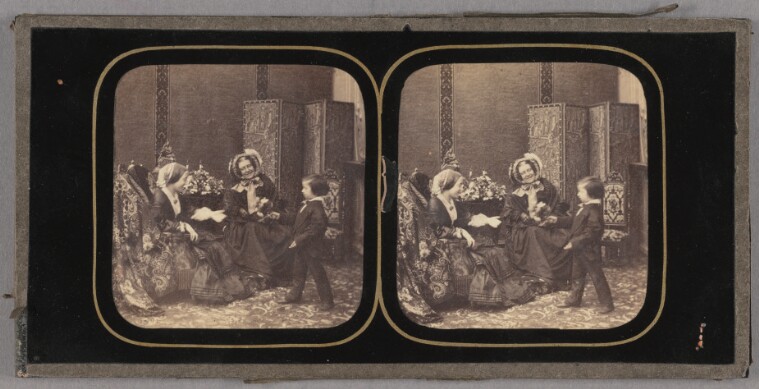 [Two women seated, little boy presenting them with a bouquet of flowers] (84.XH.710.1)