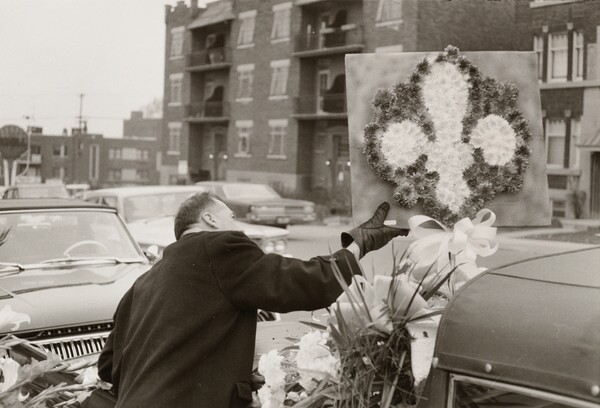 [Man adjusting funeral flowers] (84.XM.233.17)